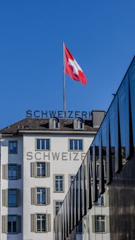 Modern and classic Swiss architecture under a clear sky in Lucerne, Switzerland.
